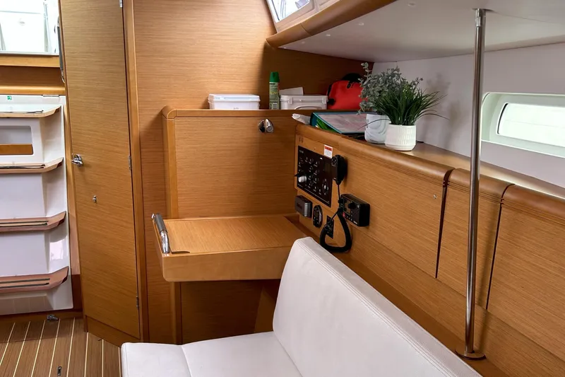 Patience Yacht Photos Pics Interior of 2012 Jeanneau Sun Odyssey 379 sailboat with navigation station and seating.