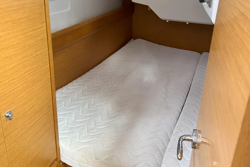 Patience Yacht Photos Pics Cabin interior of 2012 Jeanneau Sun Odyssey 379 with a neatly made bed.