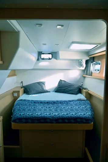 Blue Osprey Yacht Photos Pics Interior cabin of 2020 Lagoon 450S catamaran with cozy bed and nautical decor.