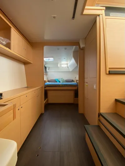 Blue Osprey Yacht Photos Pics Interior of 2020 Lagoon 450S yacht, featuring modern wood cabinetry and cozy sleeping area.