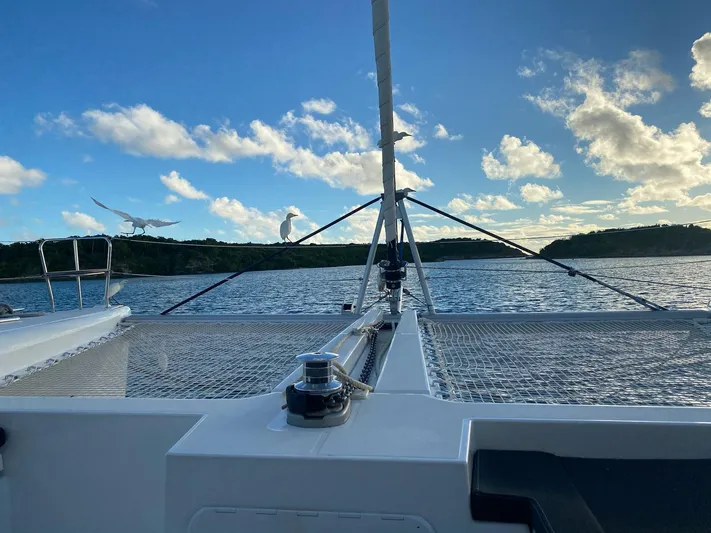 Blue Osprey Yacht Photos Pics 2020 Lagoon 450S catamaran sailing on calm waters under a blue sky.