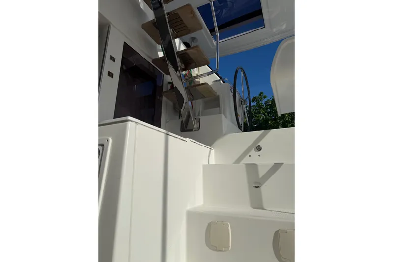 Blue Osprey Yacht Photos Pics Lagoon 450S 2020 yacht interior with stairs and steering wheel under clear sky.