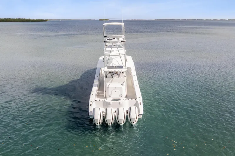  Yacht Photos Pics 2018 Yellowfin 42 Offshore boat with multiple engines on calm water.