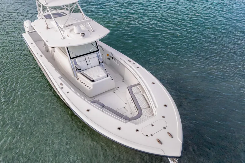  Yacht Photos Pics 2018 Yellowfin 42 Offshore boat on clear blue water, showcasing sleek design and spacious deck.