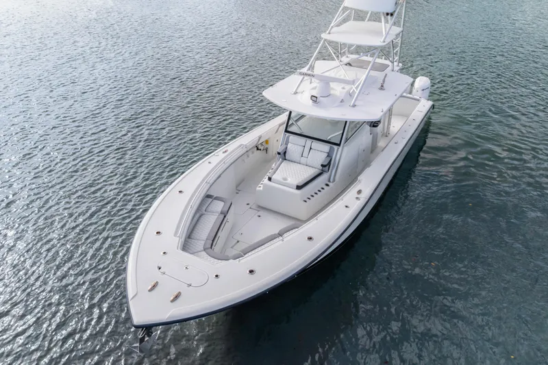  Yacht Photos Pics 2018 Yellowfin 42 Offshore boat on calm water, showcasing sleek design and spacious deck.