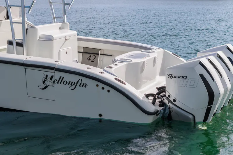  Yacht Photos Pics 2018 Yellowfin 42 Offshore boat with powerful outboard engines on calm water.