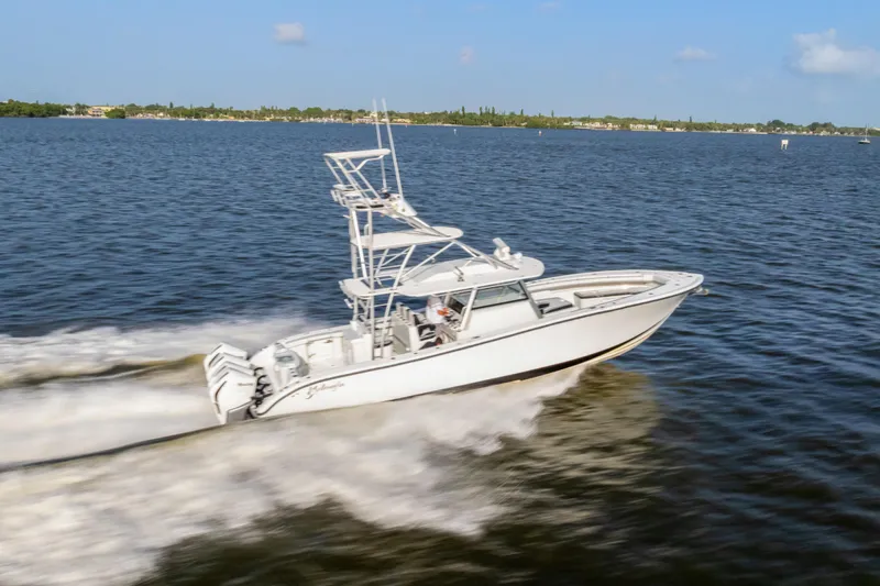  Yacht Photos Pics 2018 Yellowfin 42 Offshore boat speeding on open water under clear skies.