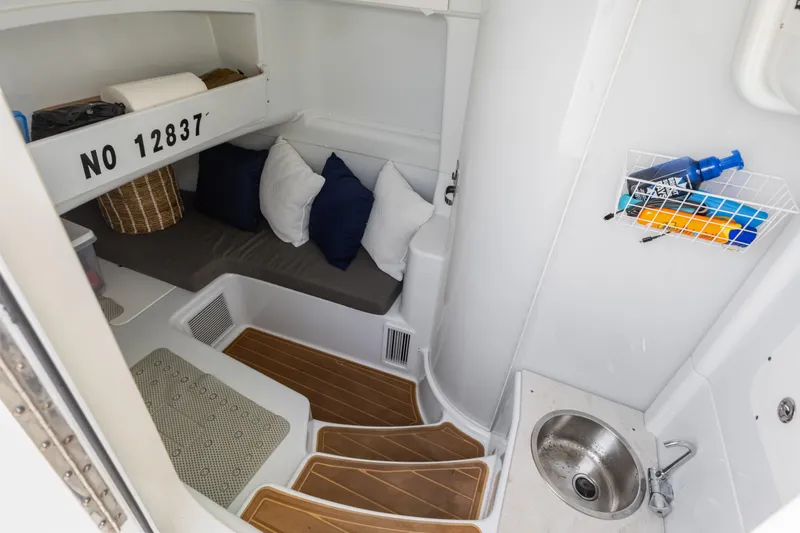  Yacht Photos Pics 2018 Yellowfin 42 Offshore cabin interior with seating, sink, and storage.