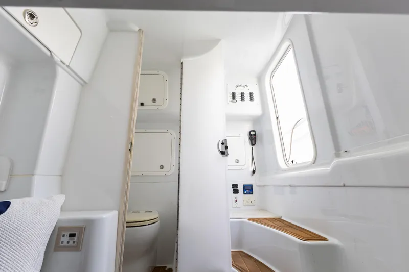  Yacht Photos Pics Interior of 2018 Yellowfin 42 Offshore boat, featuring a compact bathroom and seating area.