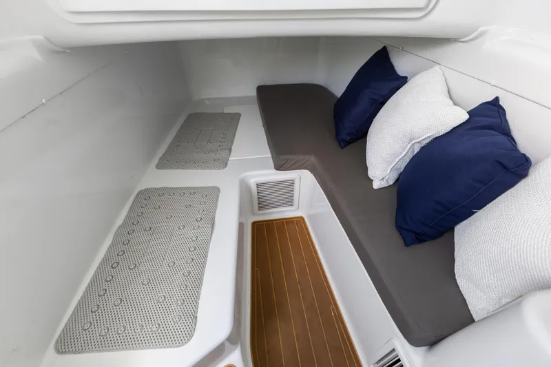  Yacht Photos Pics 2018 Yellowfin 42 Offshore cabin interior with cushions and wooden flooring.