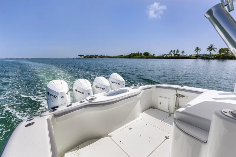  Yacht Photos Pics 2018 Yellowfin 42 Offshore boat cruising with four engines on a sunny day.