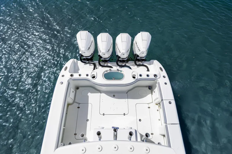  Yacht Photos Pics 2018 Yellowfin 42 Offshore boat with four outboard engines on blue water.