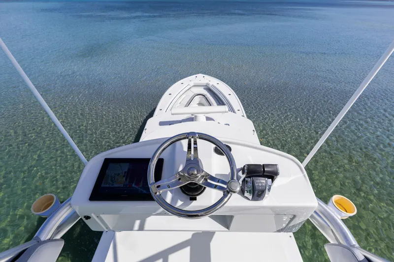  Yacht Photos Pics 2018 Yellowfin 42 Offshore boat steering console on clear water.