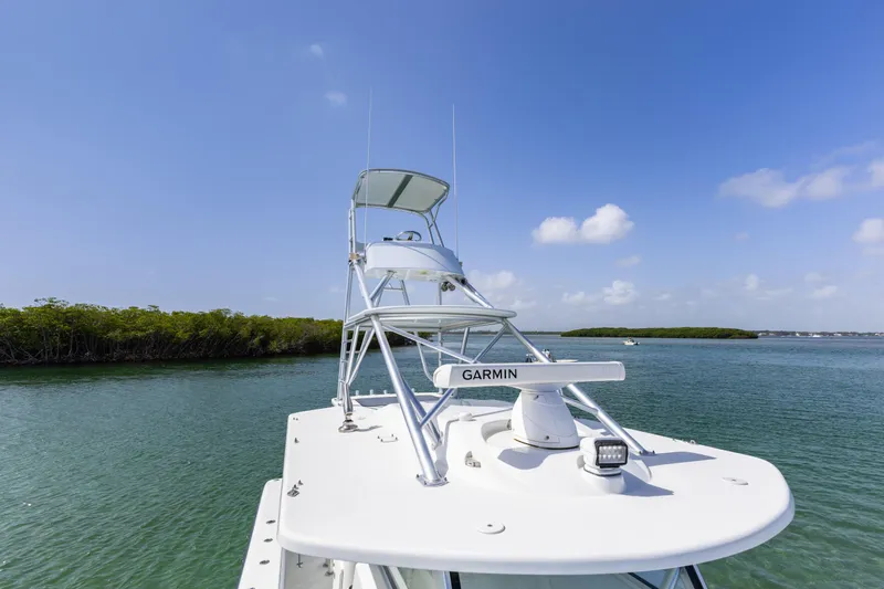  Yacht Photos Pics 2018 Yellowfin 42 Offshore boat on calm water under clear blue sky.