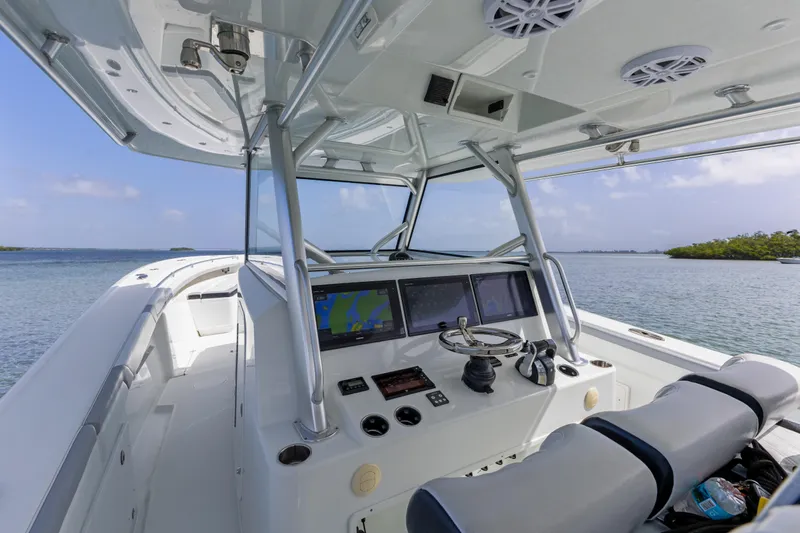  Yacht Photos Pics 2018 Yellowfin 42 Offshore boat cockpit with navigation screens and steering wheel.