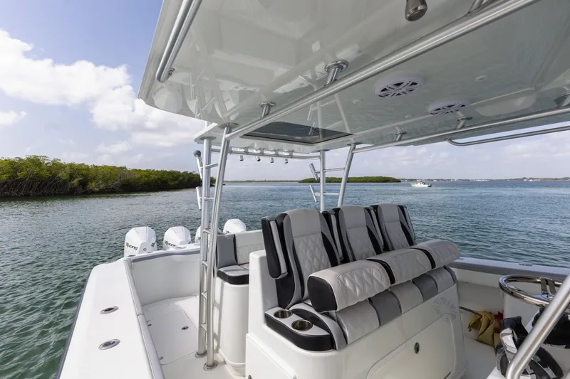  Yacht Photos Pics 2018 Yellowfin 42 Offshore boat interior with seating, on a calm waterway.