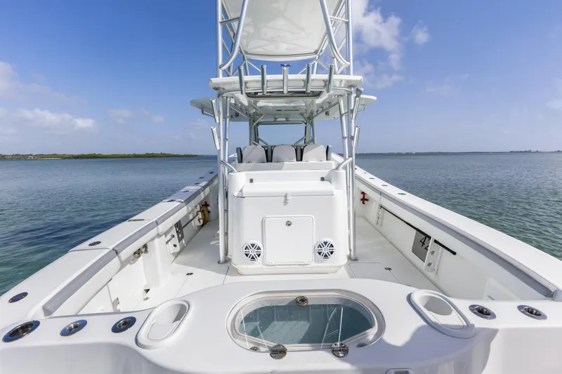  Yacht Photos Pics 2018 Yellowfin 42 Offshore boat on calm water, showcasing spacious deck and seating.
