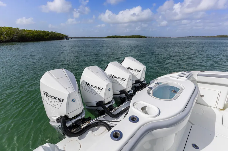  Yacht Photos Pics 2018 Yellowfin 42 Offshore boat with triple outboard engines on calm water.