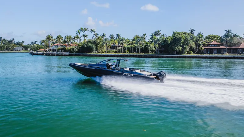 Heavy D Yacht Photos Pics 2023 Pirelli Tecnorib 50 speedboat cruising on a tropical waterway.