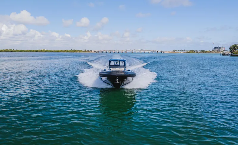 Heavy D Yacht Photos Pics 2023 Pirelli Tecnorib 50 cruising on open water under a clear blue sky.