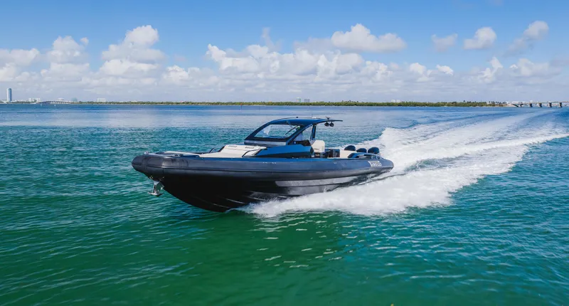 Heavy D Yacht Photos Pics 2023 Pirelli Tecnorib 50 speedboat cruising on clear blue water.