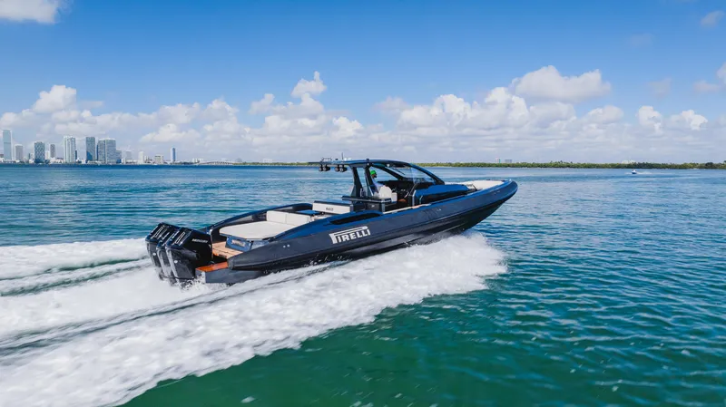 Heavy D Yacht Photos Pics 2023 Pirelli Tecnorib 50 speedboat cruising on open water under a clear blue sky.