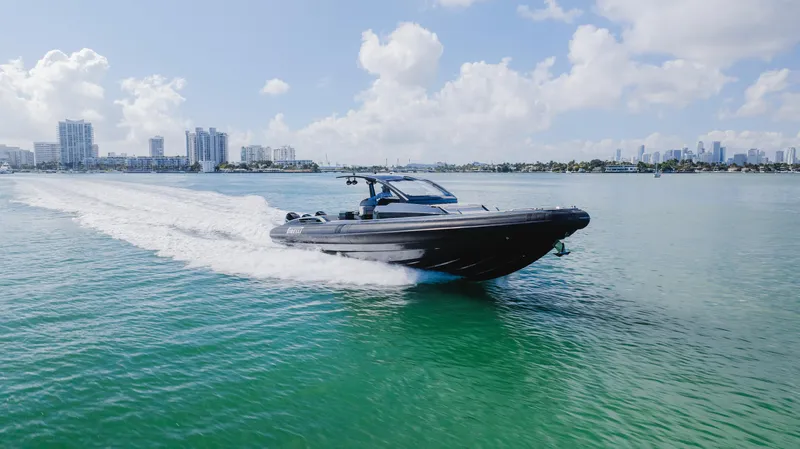 Heavy D Yacht Photos Pics 2023 Pirelli Tecnorib 50 speedboat cruising on clear blue water under a sunny sky.
