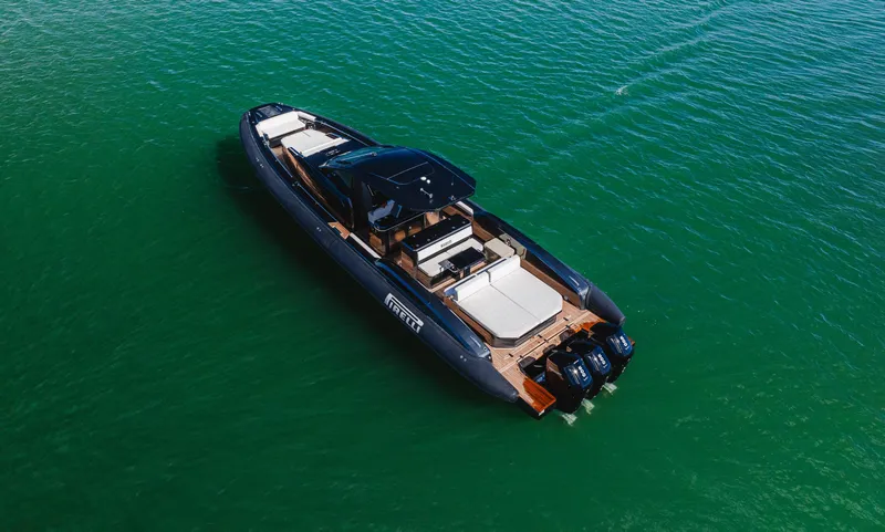 Heavy D Yacht Photos Pics 2023 Pirelli Tecnorib 50 luxury boat on calm green water.