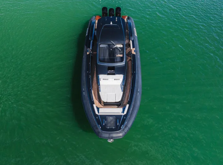 Heavy D Yacht Photos Pics 2023 Pirelli Tecnorib 50 boat on clear green water, aerial view.