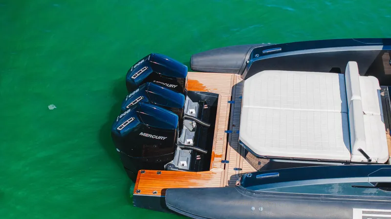 Heavy D Yacht Photos Pics 2023 Pirelli Tecnorib 50 boat with triple Mercury engines on green water.