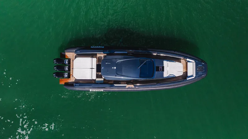 Heavy D Yacht Photos Pics Aerial view of 2023 Pirelli Tecnorib 50 boat on green water.