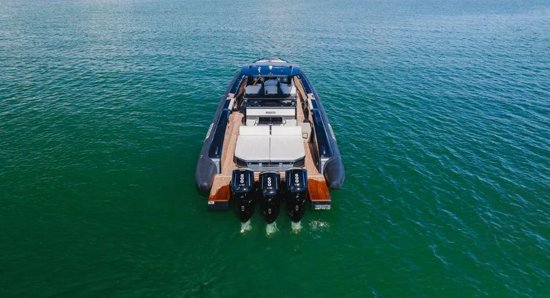 Heavy D Yacht Photos Pics 2023 Pirelli Tecnorib 50 luxury boat on open water, rear view.