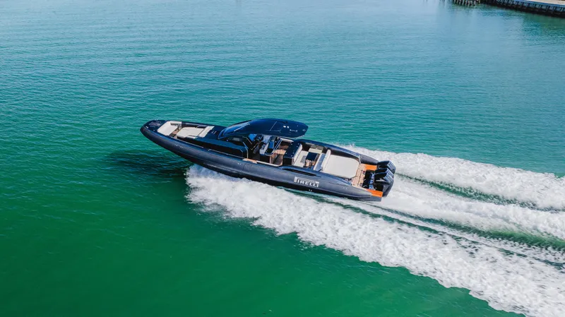 Heavy D Yacht Photos Pics 2023 Pirelli Tecnorib 50 speedboat cruising on clear turquoise water.