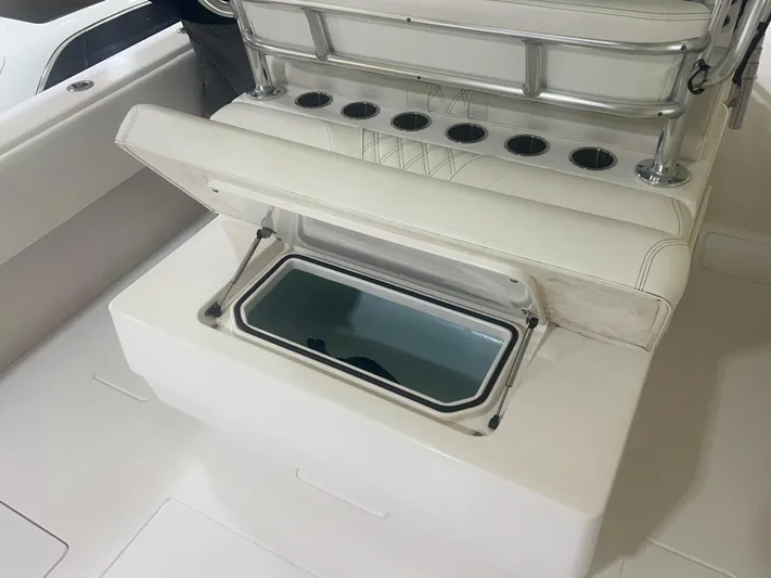  Yacht Photos Pics 2022 Contender 39 ST boat with open storage compartment and rod holders.