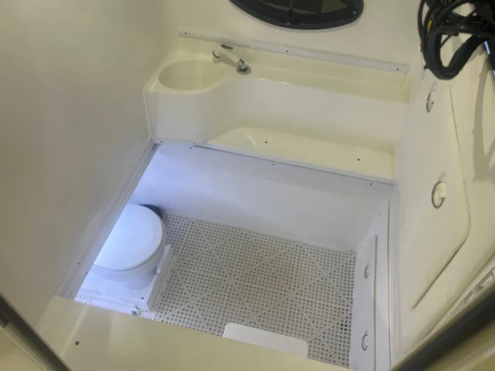  Yacht Photos Pics 2022 Contender 39 ST boat bathroom interior with sink and toilet.