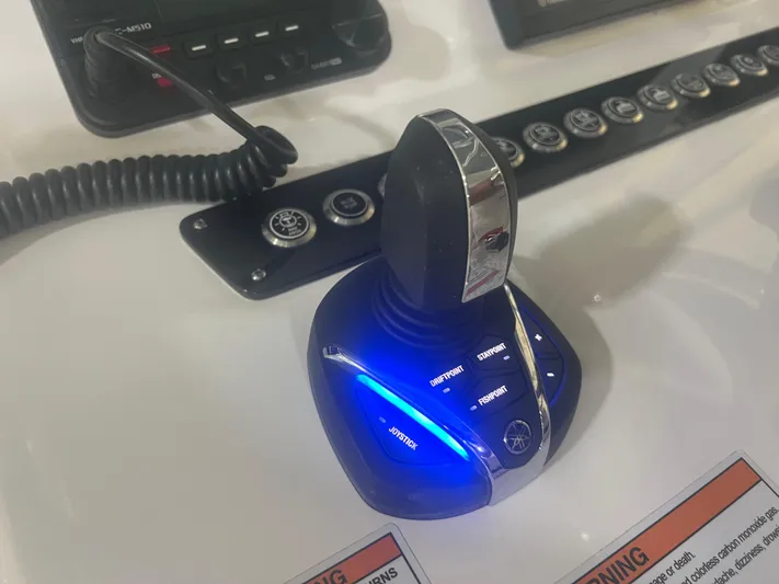  Yacht Photos Pics 2022 Contender 39 ST boat control panel with illuminated joystick and buttons.