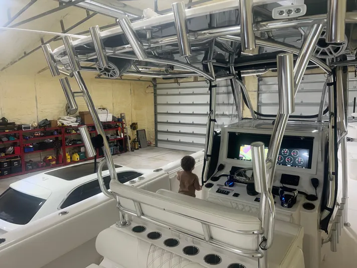  Yacht Photos Pics 2022 Contender 39 ST boat in garage, featuring advanced navigation system and sleek design.