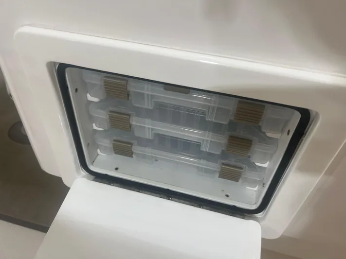  Yacht Photos Pics Storage compartment with tackle boxes in a 2022 Contender 39 ST boat.