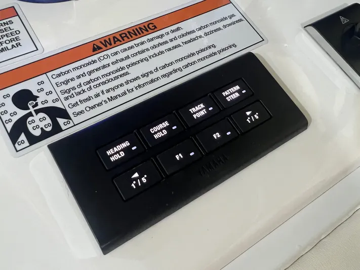  Yacht Photos Pics Control panel of a 2022 Contender 39 ST boat with warning label.