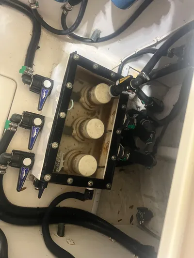  Yacht Photos Pics Engine compartment of a 2022 Contender 39 ST boat, showing hoses and valves.