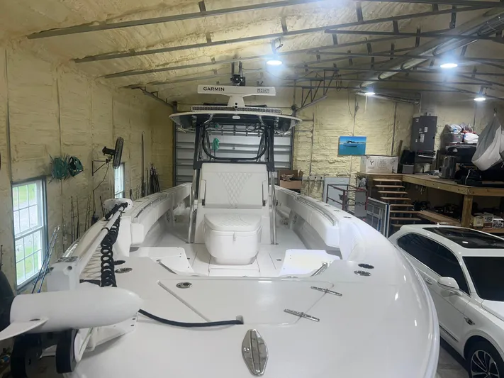  Yacht Photos Pics 2022 Contender 39 ST boat in a spacious indoor storage facility.