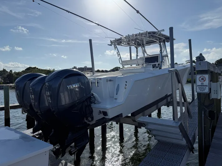  Yacht Photos Pics 2022 Contender 39 ST boat with Yamaha engines on a dock lift.