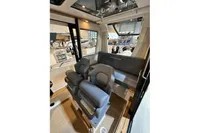 Interior of 2022 Nimbus C8 boat with modern seating and panoramic windows.