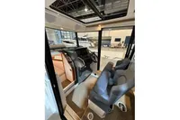 Interior of 2022 Nimbus C8 boat with modern seating and control panel.