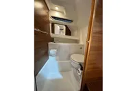 Compact bathroom in 2022 Nimbus C8 boat with wooden accents and modern fixtures.