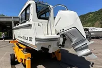 2022 Nimbus C8 boat with Mercury engine on trailer, parked outdoors.