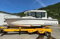 2022 Nimbus C8 boat on trailer, white exterior, parked outdoors, sunny day.