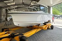 2022 Nimbus C8 boat on a yellow trailer inside a spacious garage.