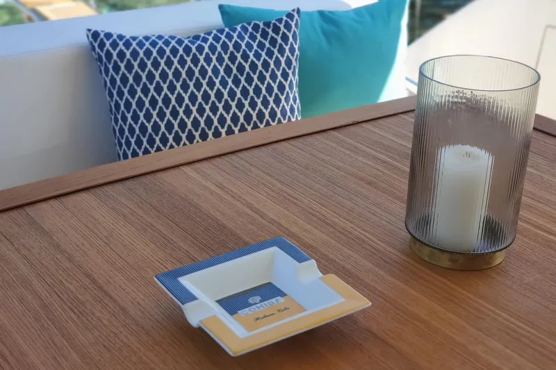  Yacht Photos Pics Elegant yacht deck with candle, ashtray, and patterned cushions, Aicon 64, 2009 model.
