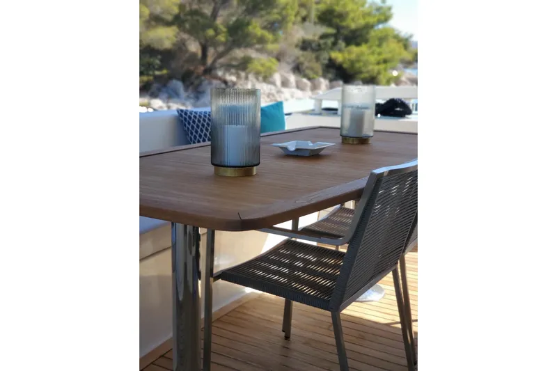  Yacht Photos Pics Outdoor dining setup on 2009 Aicon 64 yacht with wooden table and modern chairs.